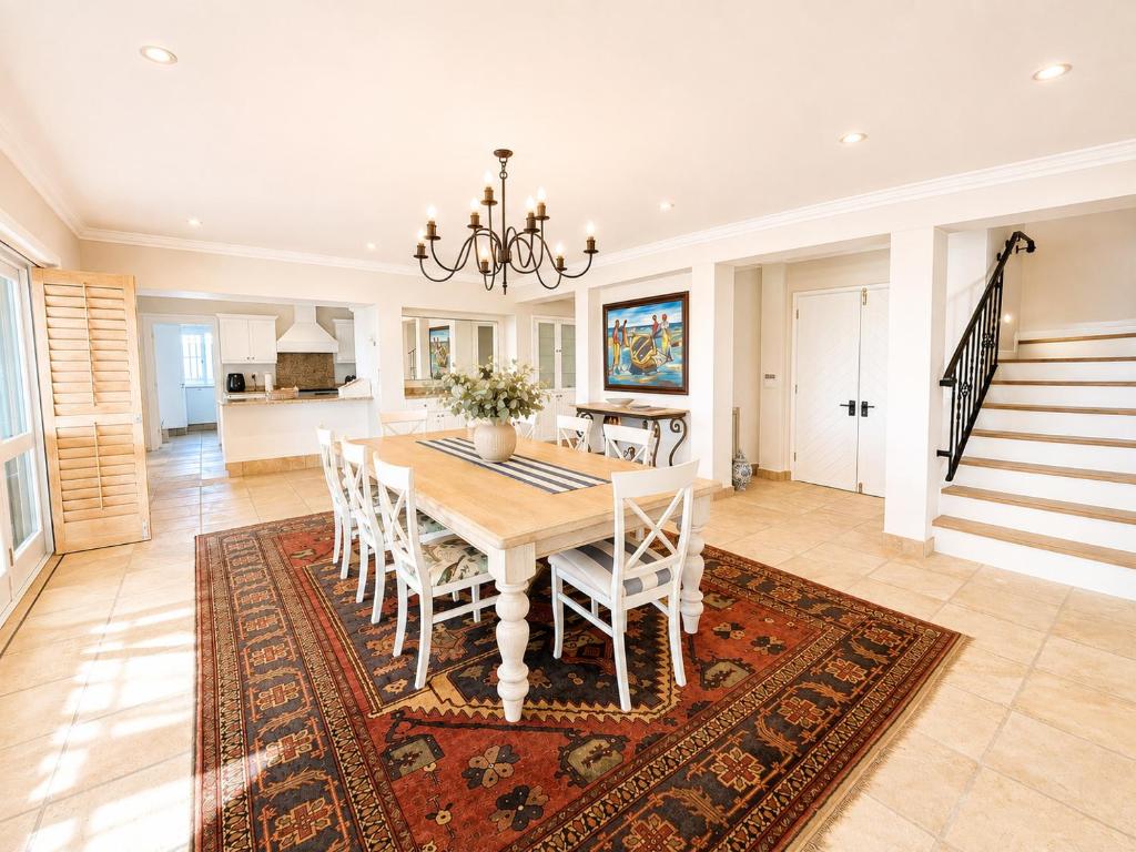 Dining table and staircase at Tremezzo Plett